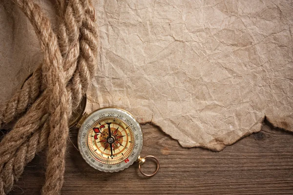 Compass, old paper and rope