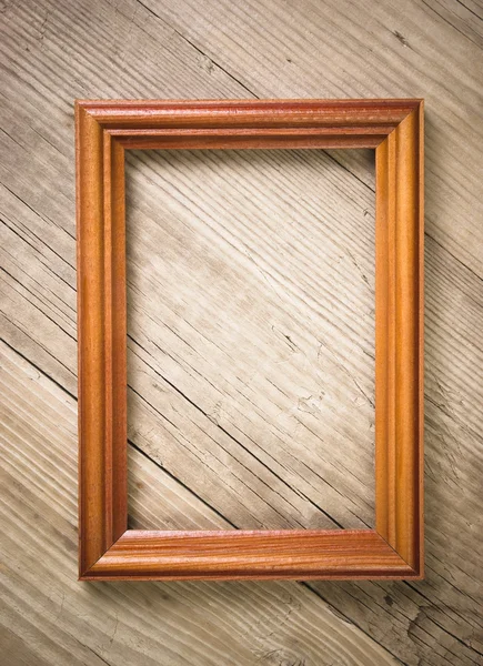 Old picture frame on a wooden background