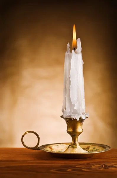 Copy space image of ablaze candle in old candlestick