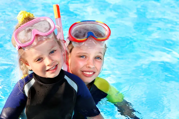 Kids in swimming pool learning snorkeling.
