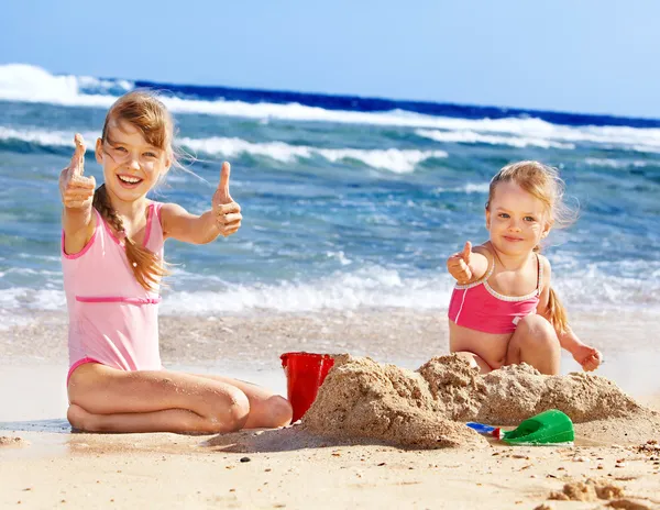 Kids playing on beach.