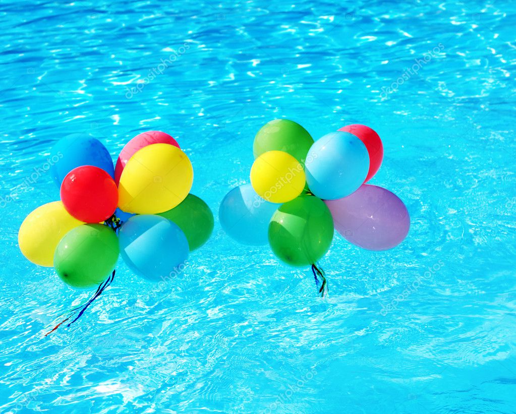 Balloons floating in swimming pool. — Stock Photo © poznyakov #6724124