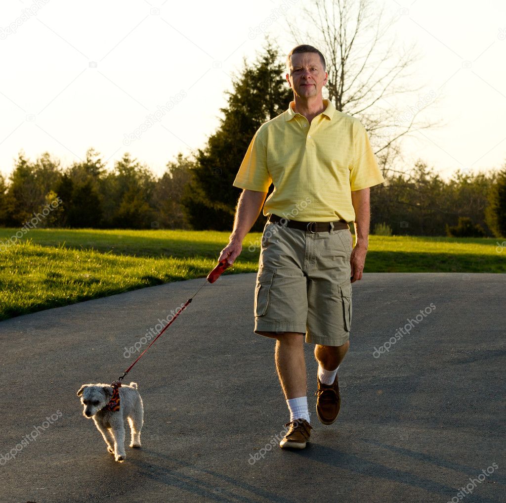 Active senior walking small dog — Stock Photo © steveheap 5425741