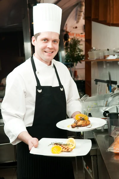 Chef with prepared food on plates