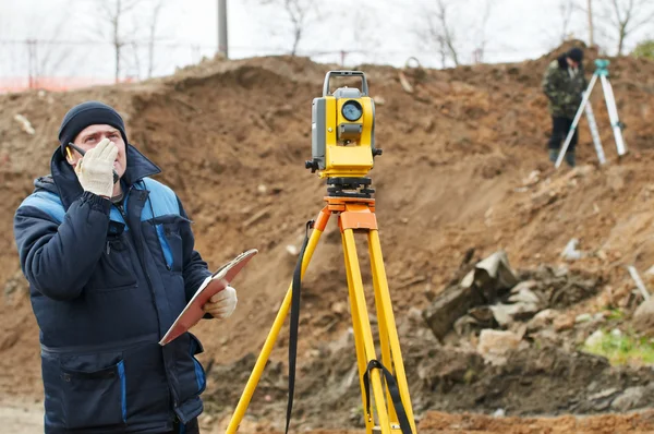 Surveyor works with theodolite tacheometer