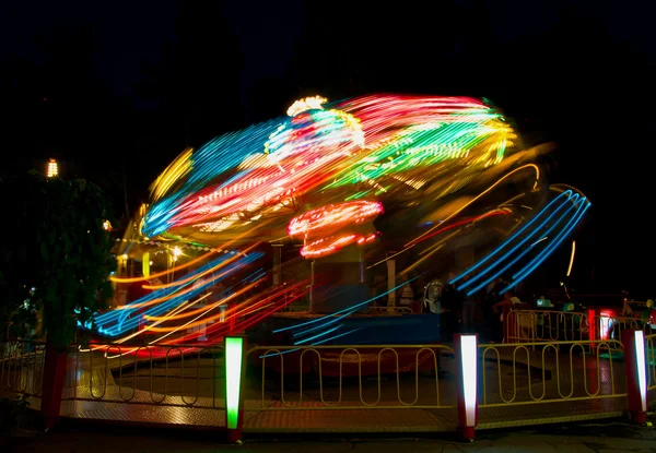 Spinning merry-go-round at night park