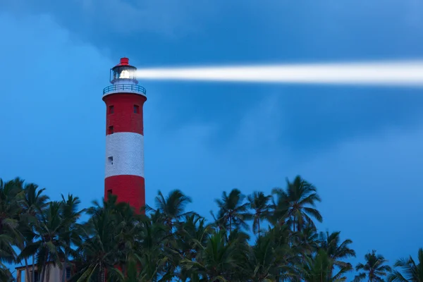 Lighthouse in night with light beam