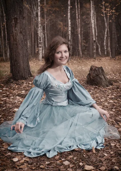 Lgirl in medieval dress in autumn wood