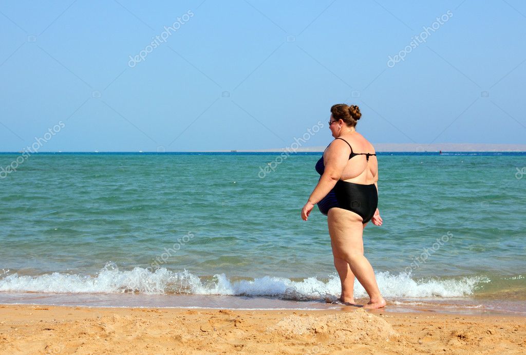 Overweight Woman Walking On Beach Stock Photo Kokhanchikov