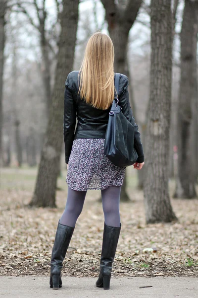 Full length, walking woman in autumn park