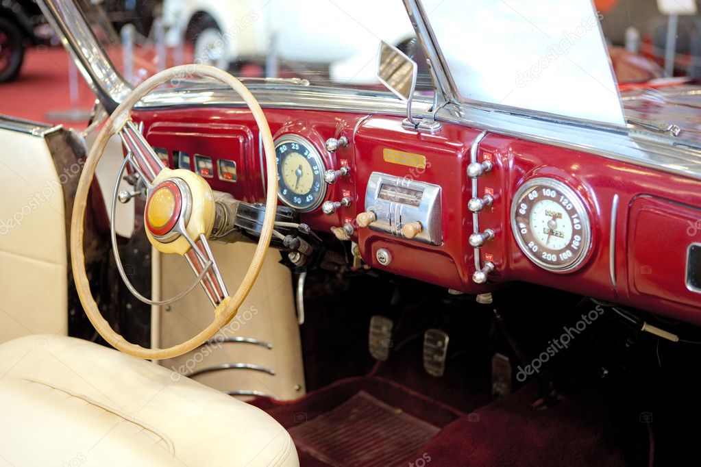 Retro styled classic car interior with red leather upholstery and matching 