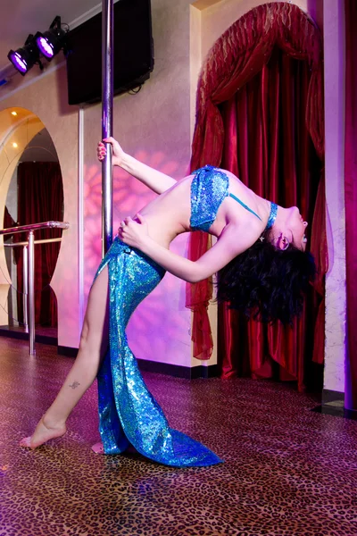 Stripper girl pole dancing in costume