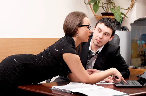 Young man and woman working together in office