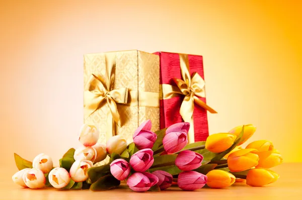 Celebration concept - gift box and tulip flowers — Stock Photo #5612876