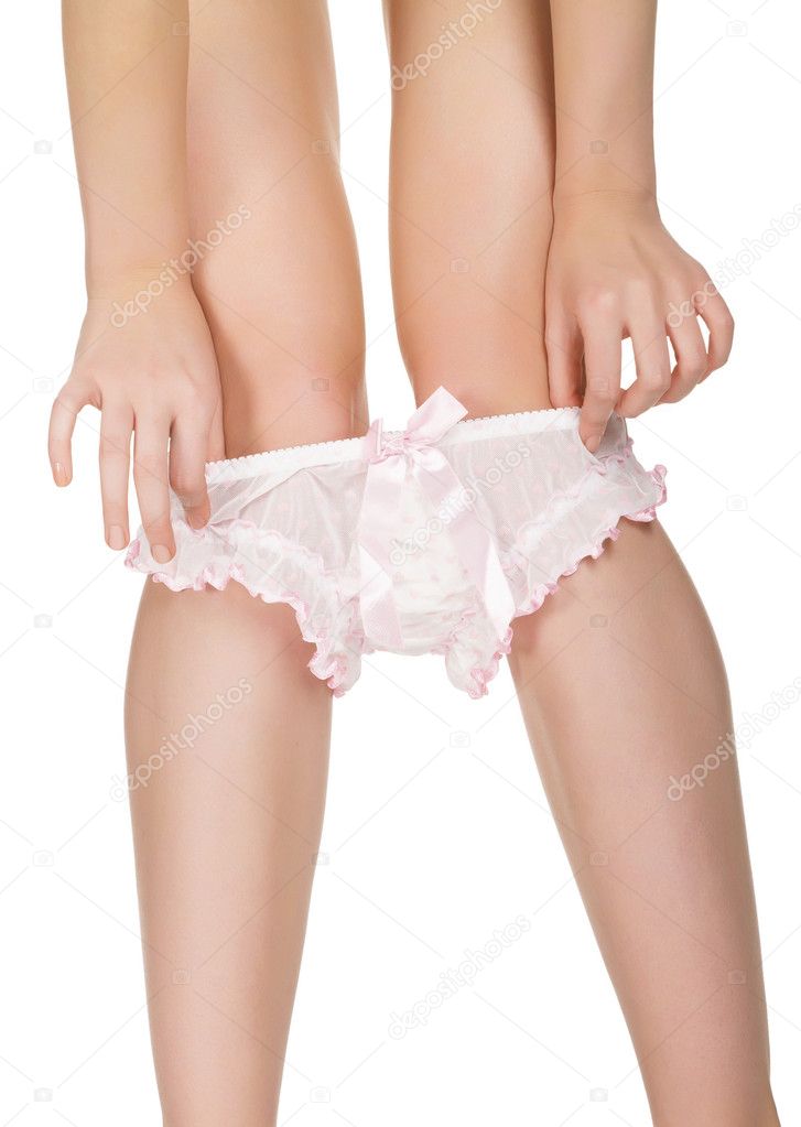 Woman takes off her panties isolated on white background