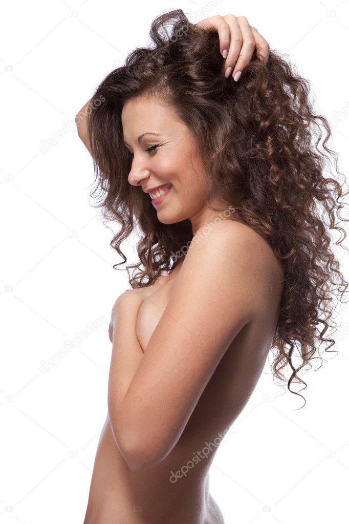 Portrait of nude woman with curly hair isolated on white