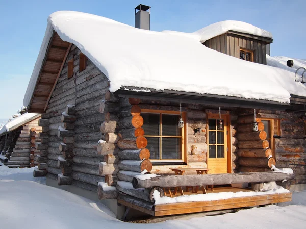 Traditional snow covered log cabin