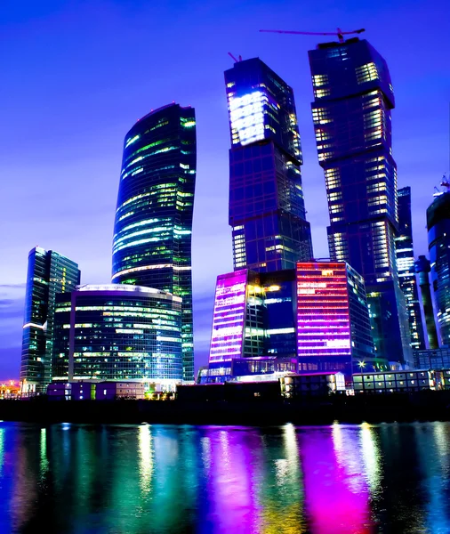 Night city of business skyscrapers in vibrant colors