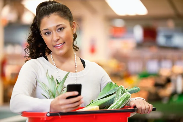 Woman with Shopping List on Phone