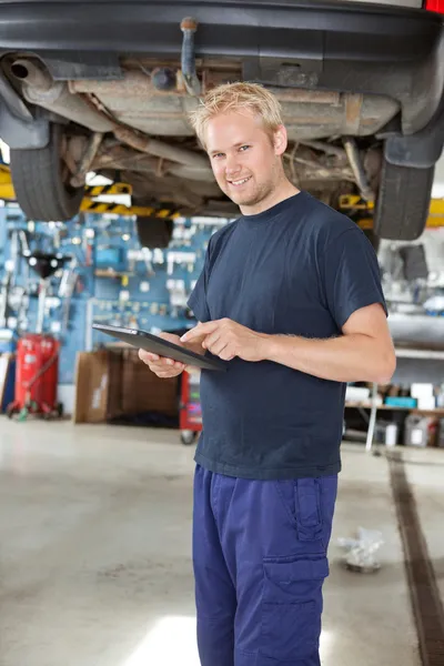 Yong mechanic with digital tablet