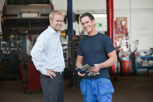 Business Customer Standing With Mechanic