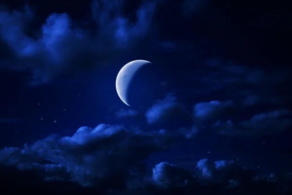 Night blue cloudy sky with stars and moon