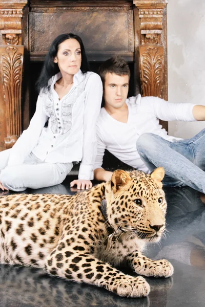 Mature woman and young man with spotty leopard