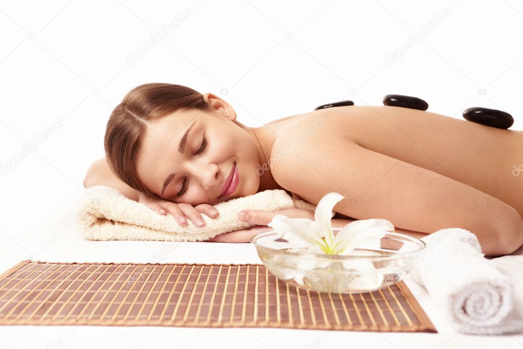 Young naked girl in a spa on a white background