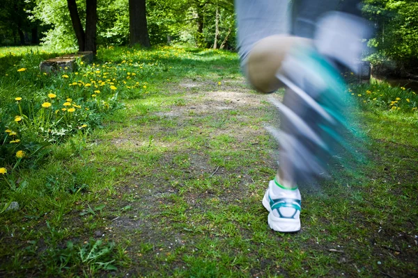 Woman running outdoors in park - motion blur