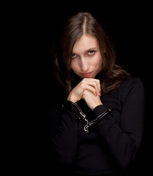 Young woman with handcuffed hands by Marcin Sadlowski Stock Photo
