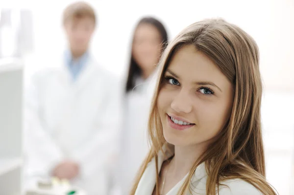 Group of scientists working at the laboratory, young beauty female research