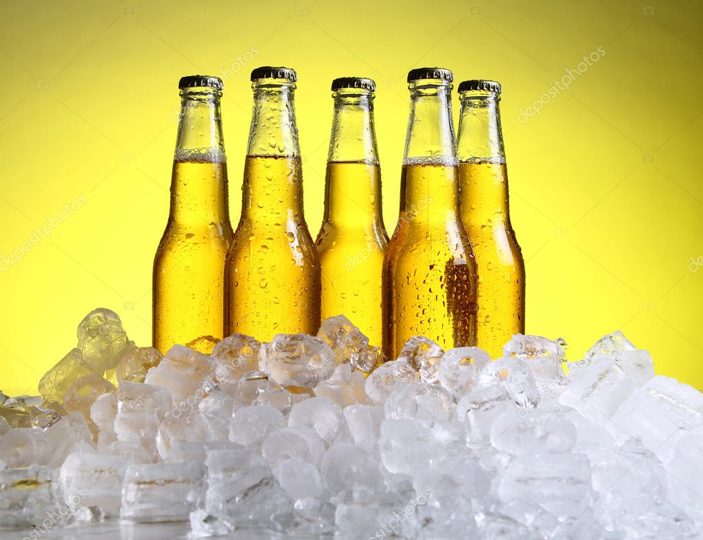Bottles of cold and fresh beer with ice — Stock Photo © yekophotostudio