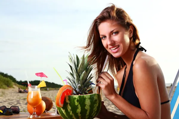 Beautiful Girl Drinking Fruit Cocktail on the Beach