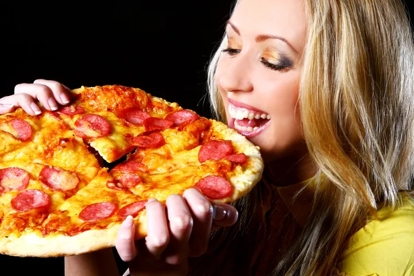 Cheerful girl eating pizza