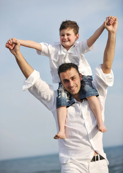 Happy father and son have fun and enjoy time on beach