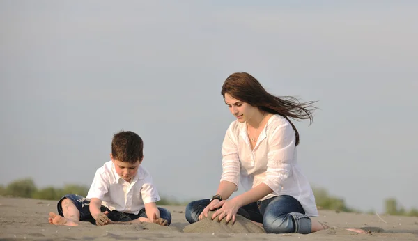 Mom and son relaxing on beach