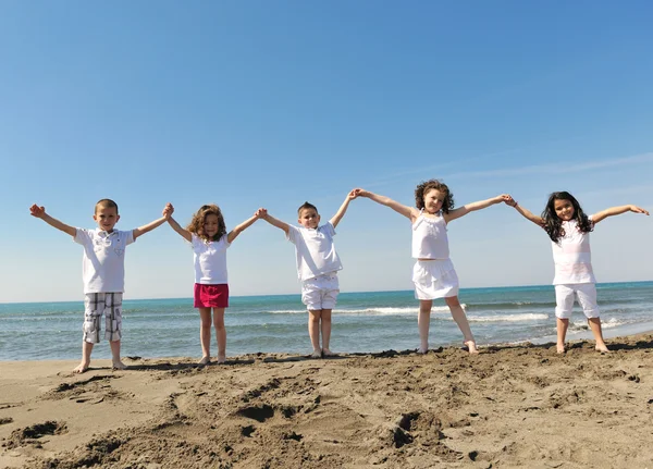 Happy child group playing on beach