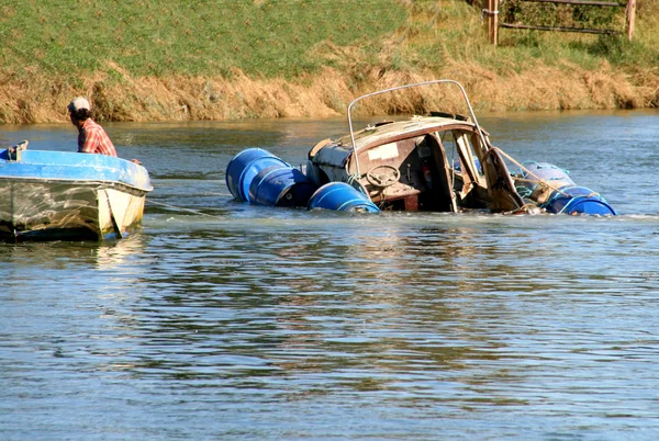 Sinking motor boat in a river