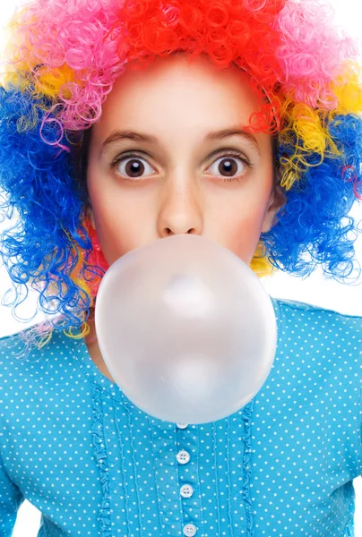 Young girl with clown wig and bubble gum