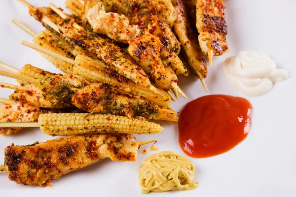 Grilled chicken white meat and baby corn on skewer