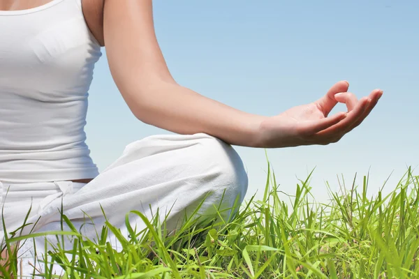 Closeup of woman hands in yoga meditation pose outdoors