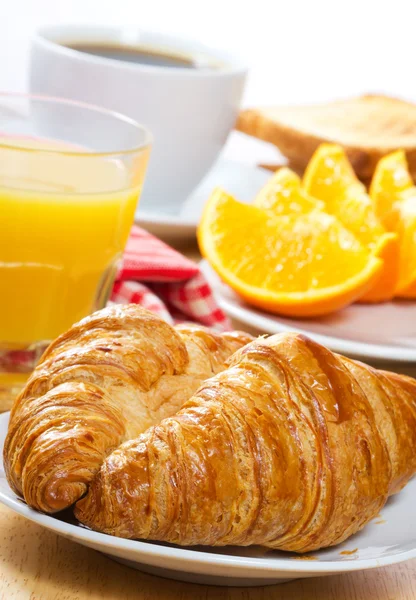 Breakfast with croissants, juice and coffee
