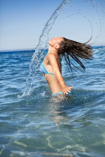 Girl with long hair in the sea