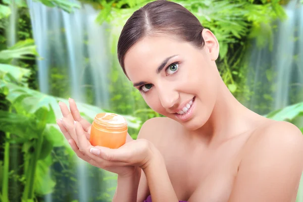 Woman holding cream for body