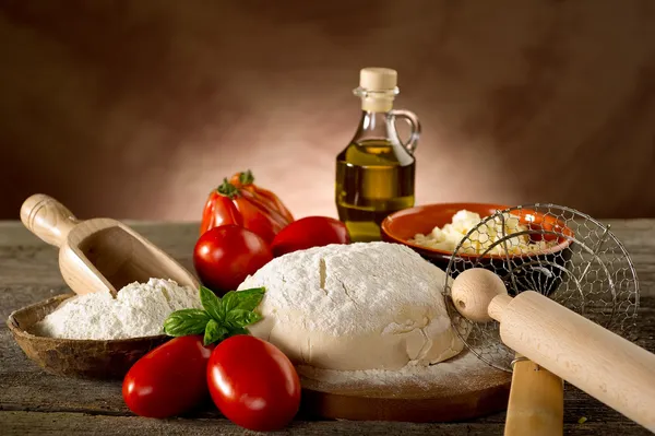 Dough and ingredients for homemade pizza