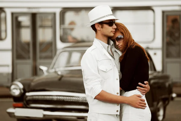 Young couple against a retro car