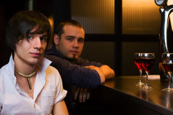 Young men relaxing in a night bar