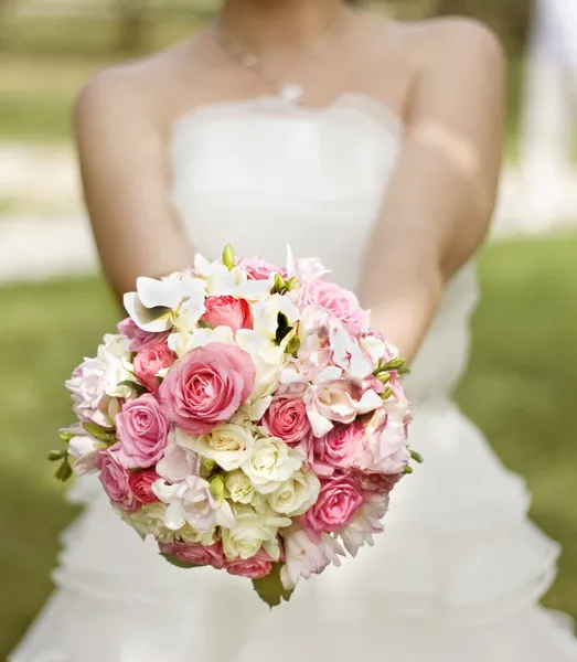 Bride in a white dress with a wedding bouquet