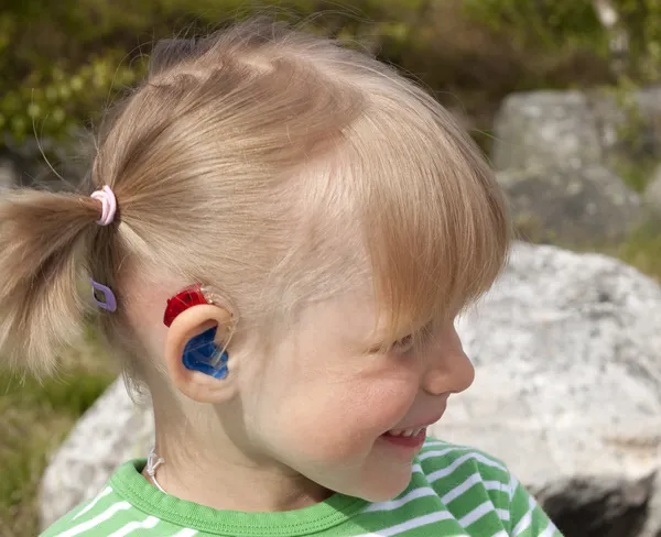 Child with hearing aid