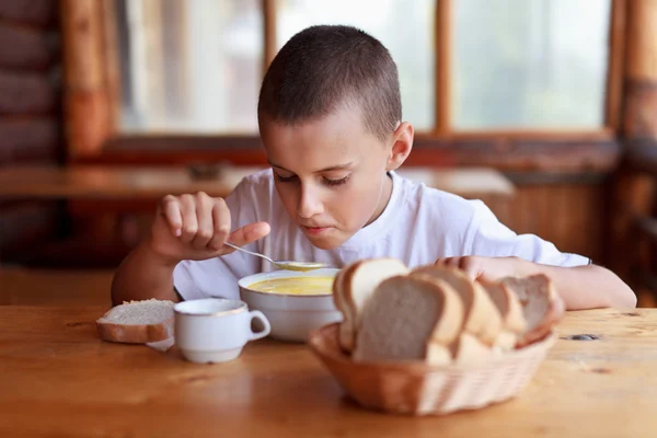 Child eating soup in a restaurant